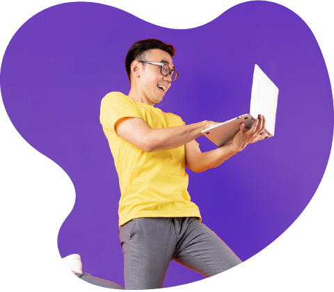 A young man in a yellow shirt excitedly holds a laptop while jumping against a purple background, conveying a sense of joy and enthusiasm in digital interaction.